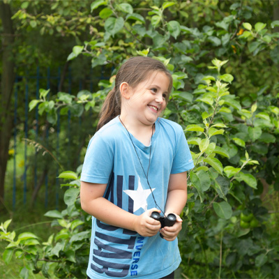Young child birdwatching in the gardens