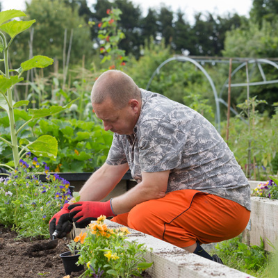 Community member tending to the gardens at The Meadows